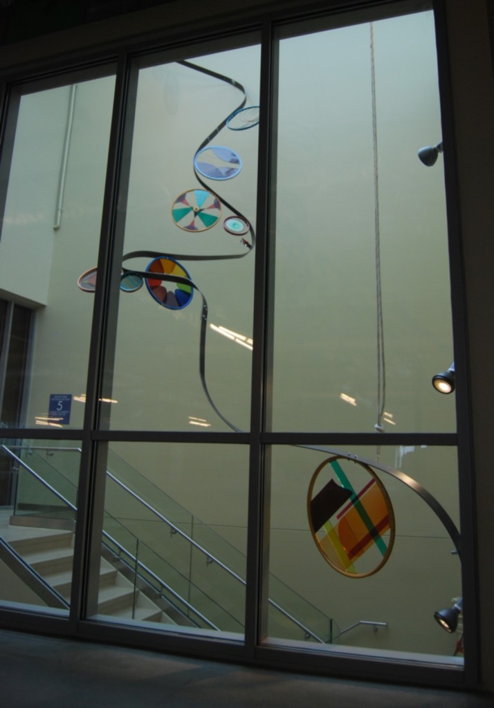 40 art glass bicycle wheels flow down 200 ft. of steel ribbon