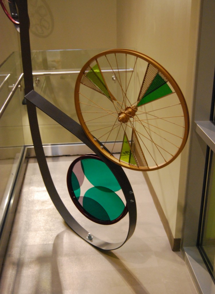 First floor detail- bicycle glass art on painted steel ribbon installation.